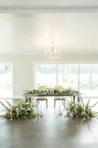 Dusty Rose Styled Wedding Shoot in White Barn, Rustic Wood Table with Greenery, Blush Pink and Ivory Roses Garland Table Runner and Organic Whimsical Floral Arrangements with Feathers | Odessa Rustic Waterfront Wedding Venue Barn at Crescent Lake | Tampa Bay Wedding Planner Elegant Affairs by Design