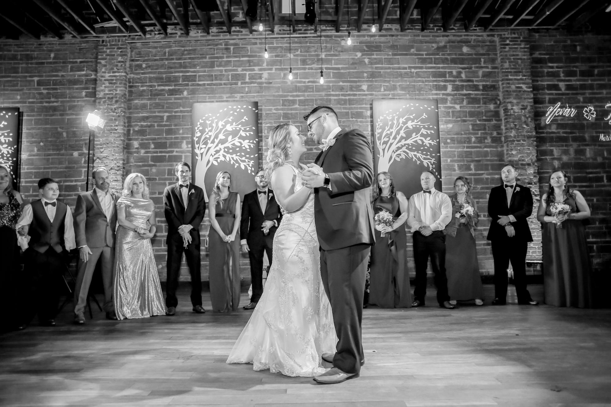 Florida Bride and Groom First Dance in the Center of Historic Wedding Venue with Exposed Brick Wall at NOVA 535