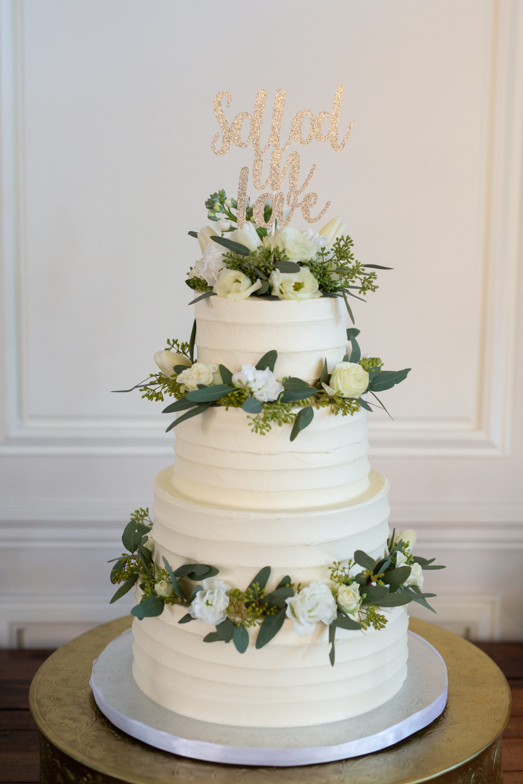 Classic Three Tier White Wedding Cake Decorated with Ivory Roses and Green Leaves with Custom Gold Cake Topper | Wedding Cake Historic Hotel The Don CeSar