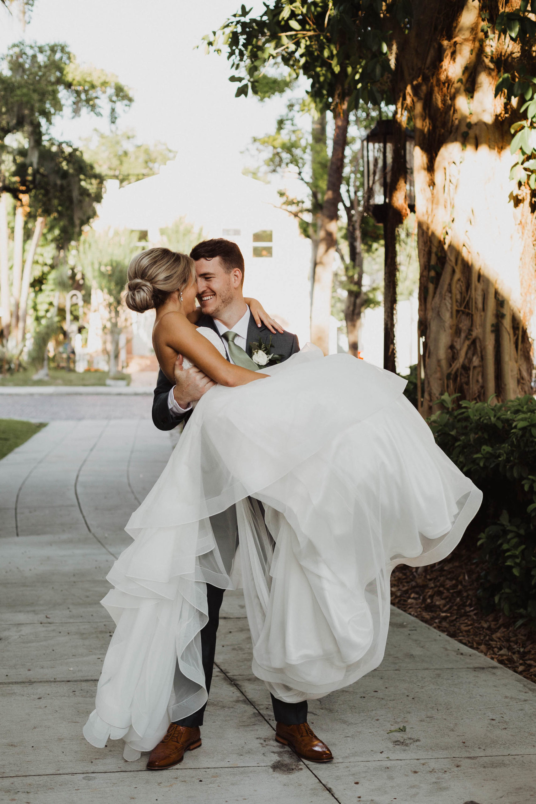 Romantic Groom Holding Bride Outdoor Tampa Wedding Portrait