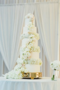 Elegant Classic Five Tier White Wedding Cake with Ivory and Blush Pink Roses Lush Cascading Flowers on Gold Cake Stand | Wedding Caterer and Cake St. Pete Vinoy Renaissance