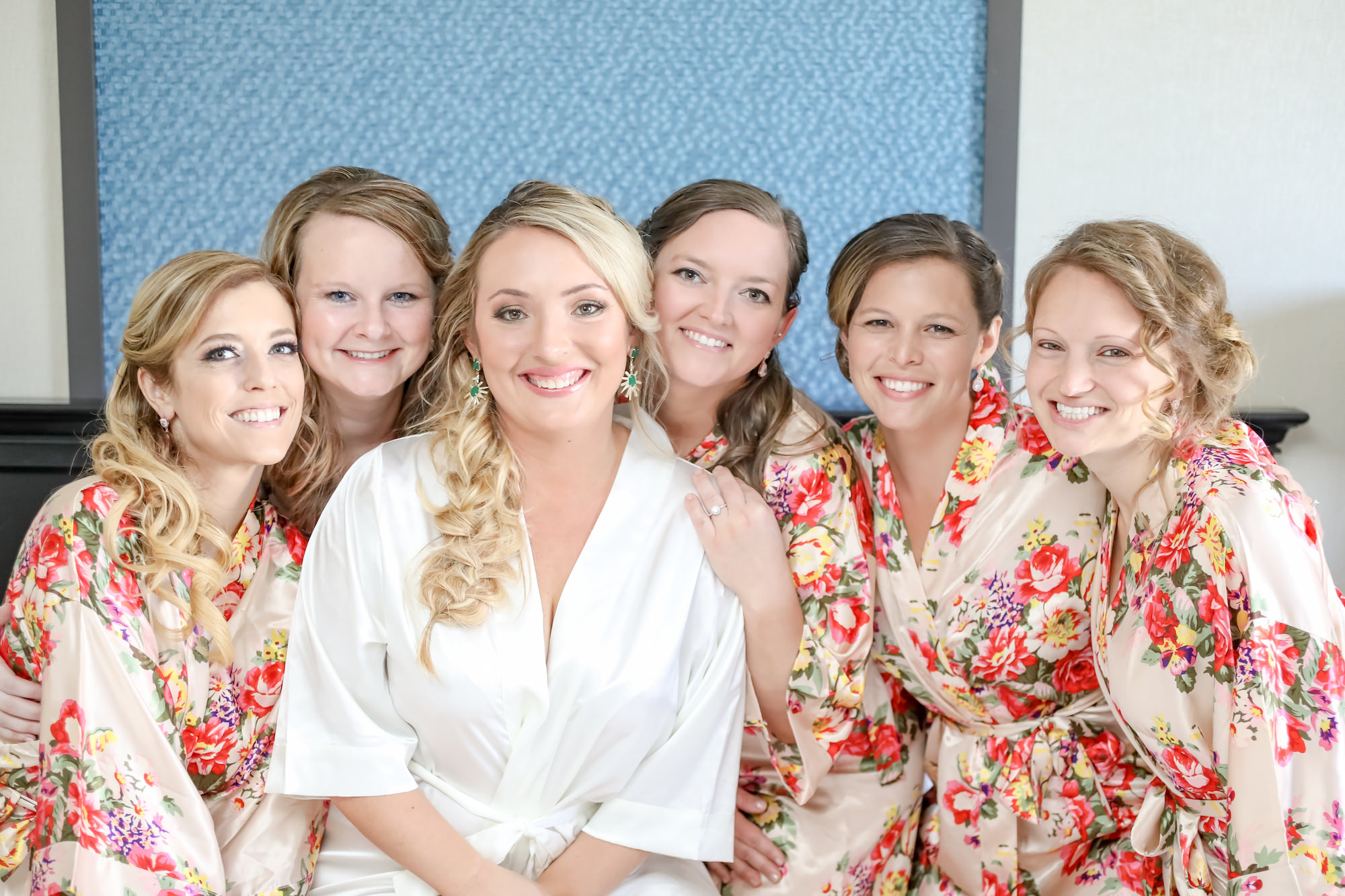 St. Pete Bride and Bridesmaid Getting Ready Photo, Champagne Gold Silk Robes with Red Floral Design, Bride Wearing Emerald Earrings | Florida Wedding Photographer Lifelong Photography Studios