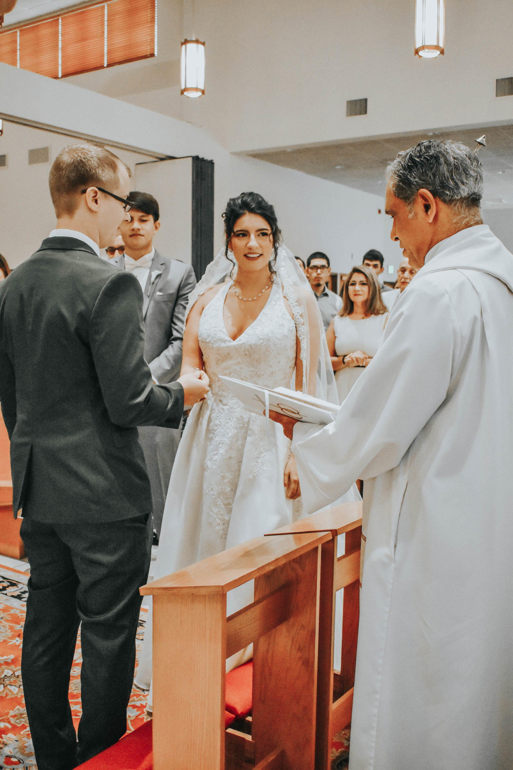 Florida Bride and Groom Exchange Vows and Hold Hands during Classic Church Wedding Ceremony in Tampa Bay