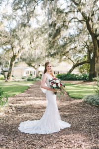 Rustic Inspired Florida Bridal Portrait, Bride Wearing Romantic Martina Liana Lace Wedding Dress, Holding FSU Florida State Inspired Bouquet, With Garnet and White Flowers, and Greenery, Outside Cross Creek Ranch in Dover Florida Wedding Hair and Makeup Artist Michelle Renee the Studio | Tampa Bay Luxury Wedding Photographer Kéra Photography