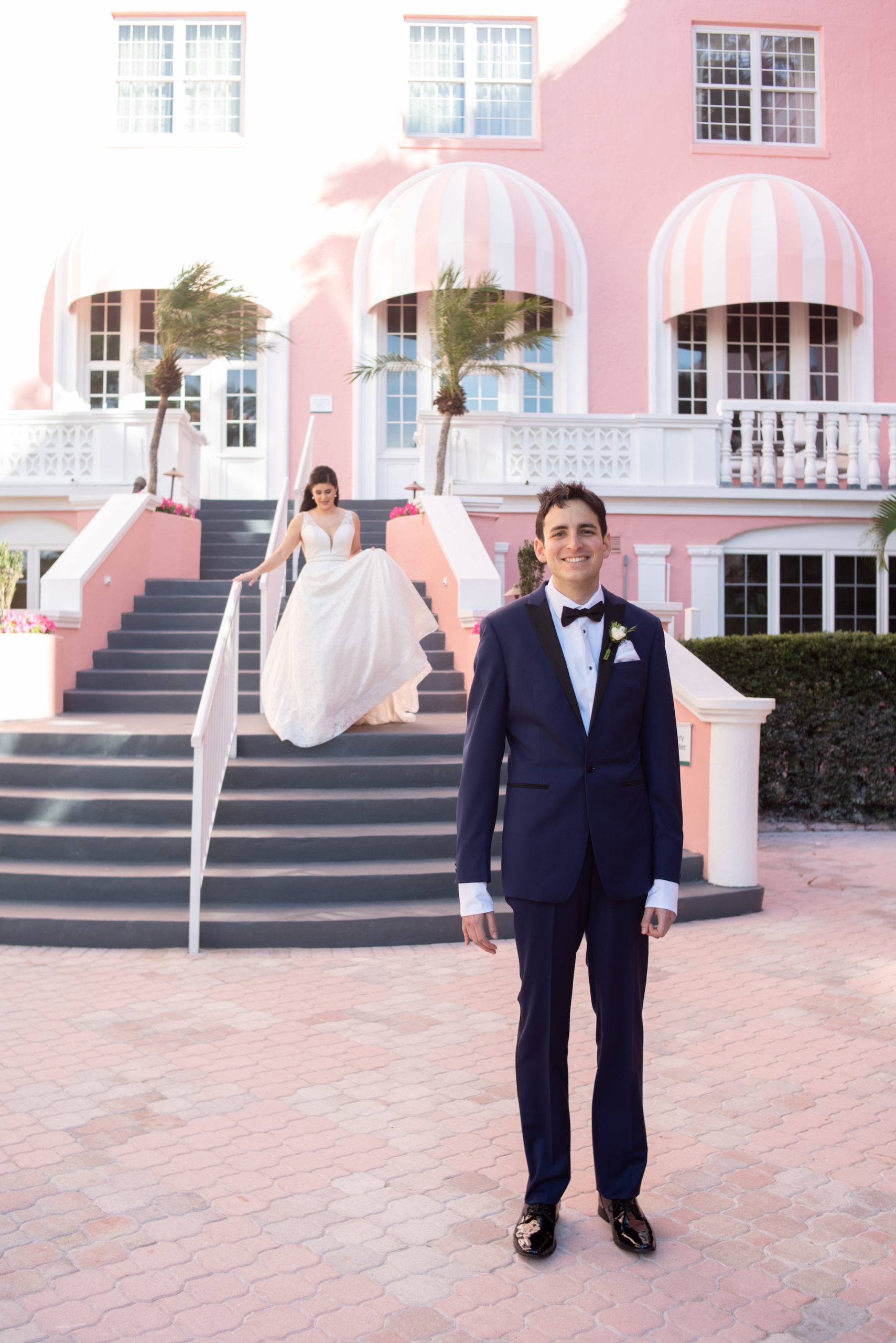 Florida Bride Walking Towards Groom First Look Wedding Portrait | The Pink Palace | St. Petersburg Waterfront Wedding Venue The Don CeSar