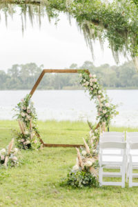 Florida Outdoor Waterfront Wedding Ceremony, Under Large Flowing Oak Tree, Rustic Wooden Hexagon Wedding Arch with Whimsical Inspired White and Dusty Rose Decor, and Pompous Grass Ceremony Flowers | Tampa Bay Wedding Planner and Day of Coordinator Elegant Affairs by Design