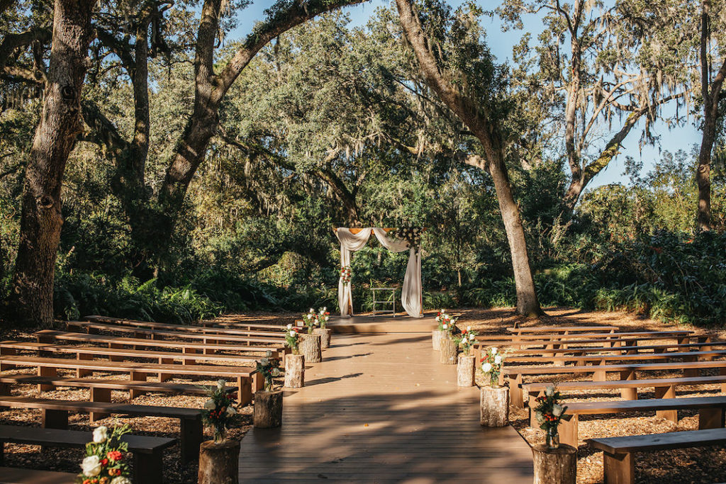 Rustic Country Wedding Venue Wood Benches Outdoor Cut Log Ceremony Aisle Decor with Draped Arch