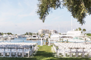 Peach, Pink, and White Wedding Ceremony Arch Decor with Greenery and Draping | Tropical Waterfront Florida Lawn Wedding Ceremony | Sarasota Wedding Venue The Resort at Longboat Key Club Marina