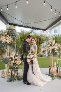 Dark Luxe, Romantic Wedding Decor, Hanging String Lights, Tall Gold Geometric Stands with Gold Monstera Leaves, Palm Fronds, Blush Pink Roses Floral Arrangements, Gold and Black Lanterns | Tampa Bay Wedding Planner Elegant Affairs by Design
