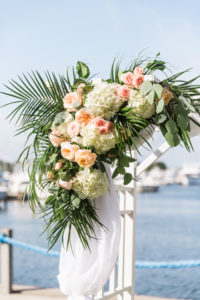 Peach, Pink, and White Tropical Wedding Ceremony Arch Decor with Greenery