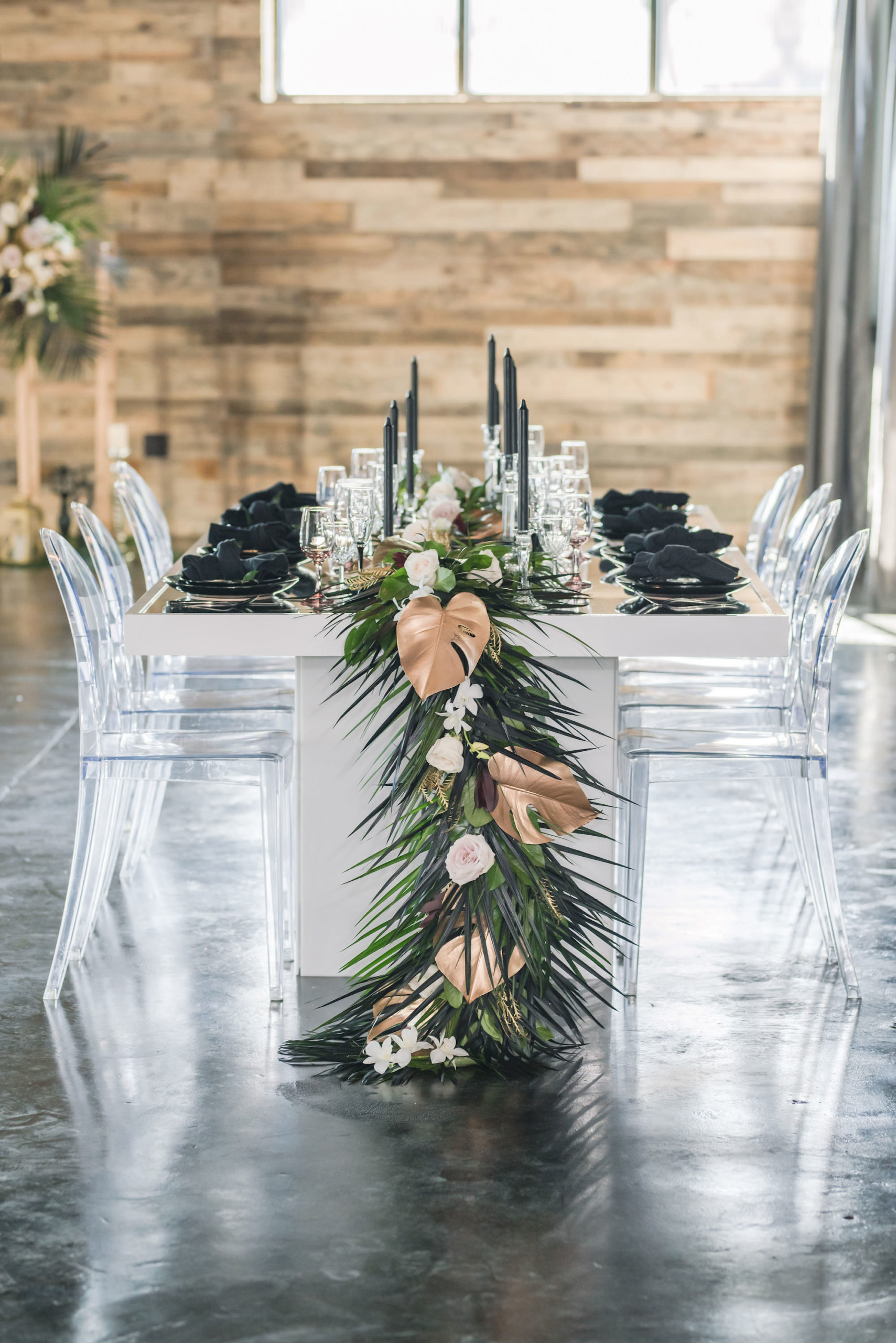 Dark Luxe, Romantic Wedding Styled Shoot Decor, Long White Table with Palm Fronds, Gold Painted Monstera Leaves, Blush Pink Table Runner, Black Candlesticks, Ghost Acrylic Chairs | Tampa Bay Wedding Planner Elegant Affairs by Design | Madeira Beach Wedding Venue The West Events Space