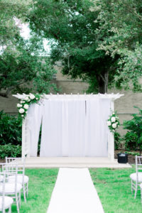 Wedding Ceremony Decor, Arbor Arch with White Draping and Floral Arrangements, White Aisle Runner, Silver Chiavari Chairs | Outdoor Wedding Venue Tampa Garden Club | Wedding Photographer Shauna and Jordon Photography