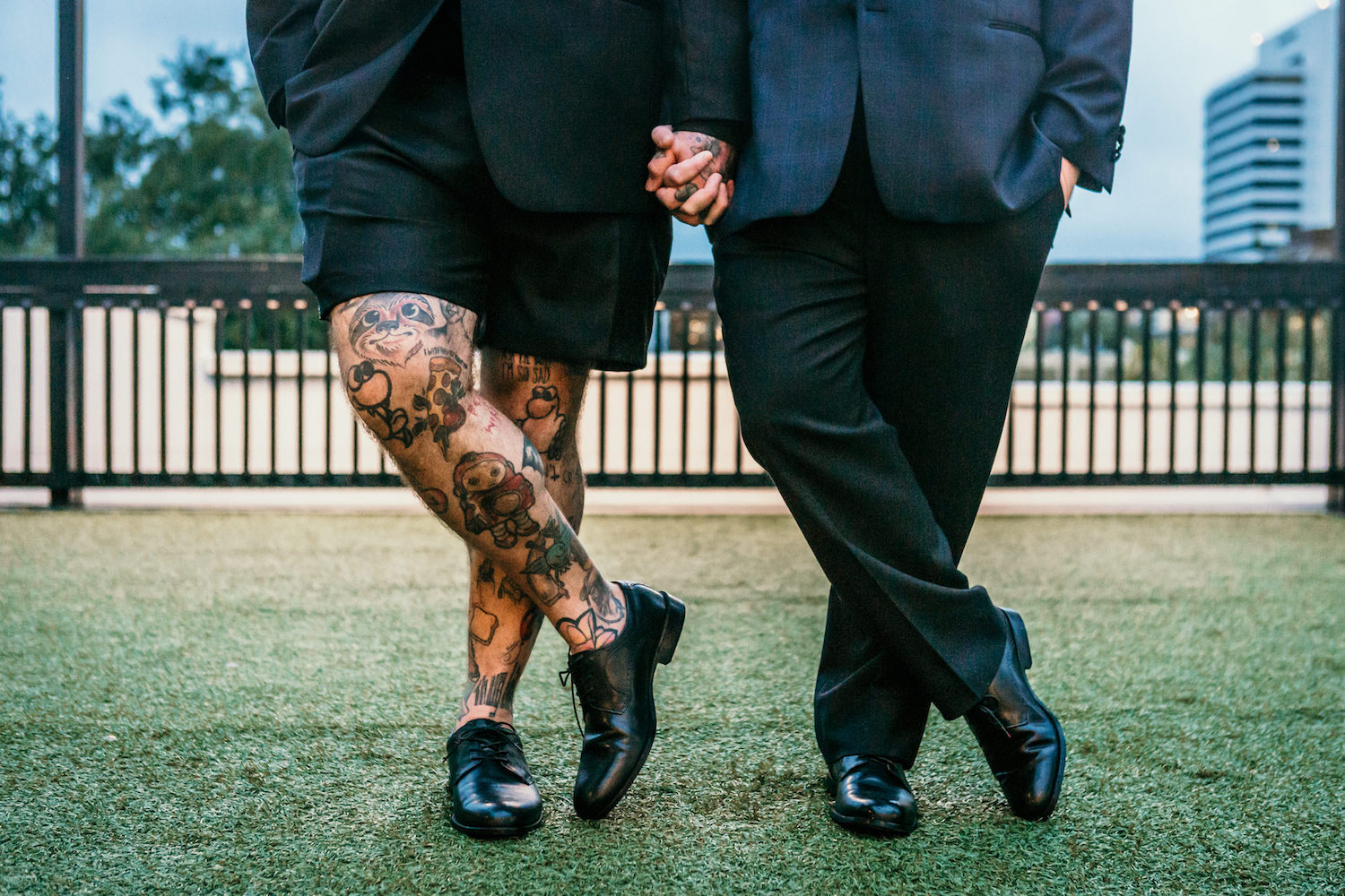 Creative Same Sex Gay Grooms Holding Hands, Groom in Dress Shorts and Leg Tattoos Wedding Portrait | St. Pete Unique Wedding Venue Station House