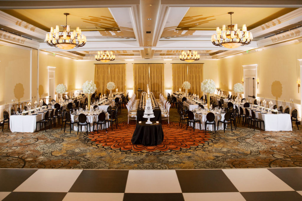 Classic Timeless Modern Ballroom Wedding Reception Decor, Black and White Checkered Dance Floor, Long Tables with White and Black Linens, Black Chairs, Tall Gold Vases with White Floral Centerpieces | Tampa Bay Wedding Planner Parties A'la Carte | Wedding Reception Venue Clearwater Beach Sandpearl Resort