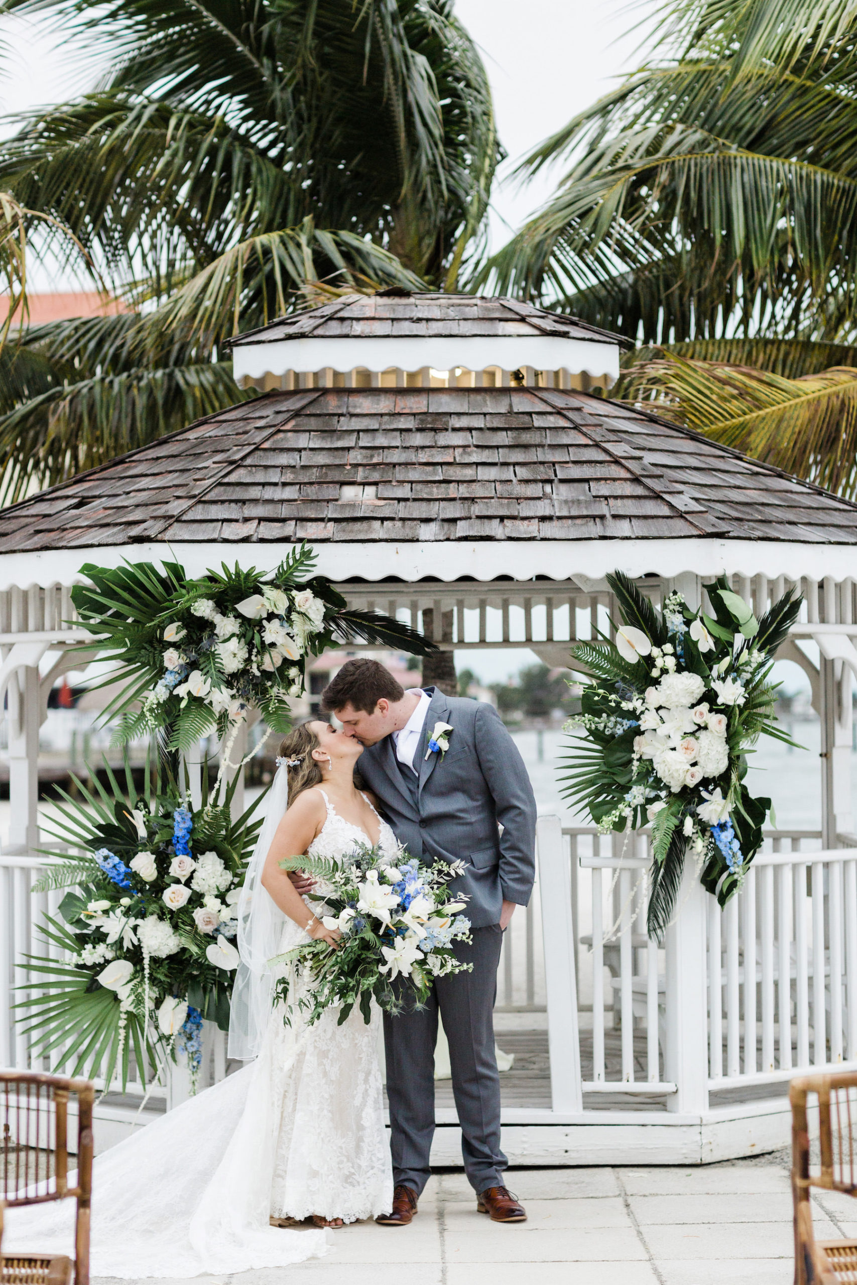 Bride and Groom Portraits at Beach Wedding Gazebo with Tropical Floral Arrangements | St. Pete Wedding Venue Isla Del Sol