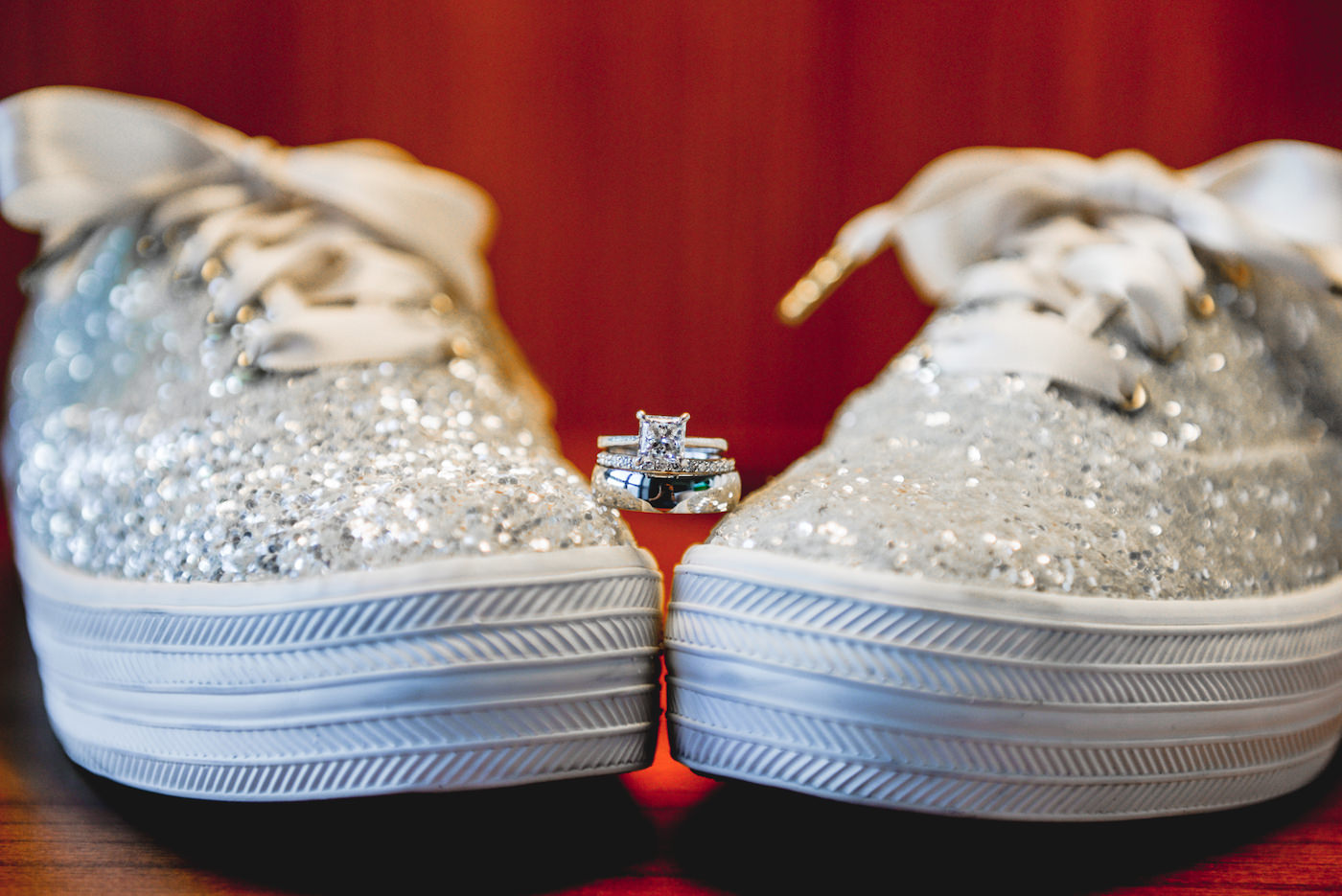 Wedding Ring Shot with Cushion Cut Solitaire Engagement Ring and Channel Set Diamond Band with Platinum Silver Groom Band | Silver Glitter Keds Sneakers Wedding Shoes