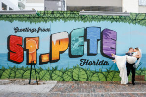 Florida Bride and Groom in front of Greetings from St. Pete Florida Wall Art Mural in Downtown St. Petersburg | Tampa Bay Wedding Photographer Lifelong Photography Studio