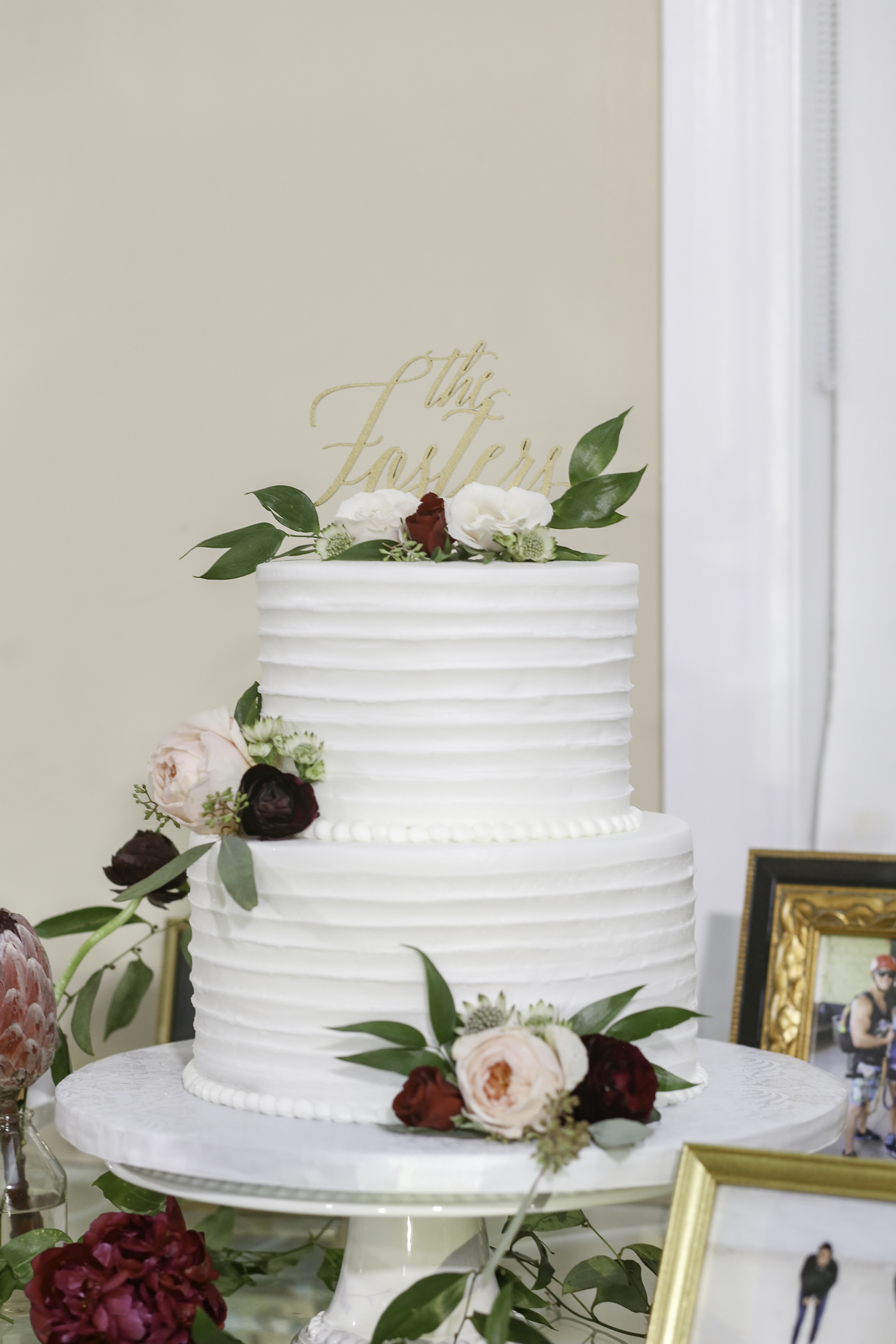 Simple Two Tier White Ruffle Textured Wedding Cake with Blush Pink and Red Roses and Greenery Leaves, Custom Gold Cake Topper | Wedding Photographer Lifelong Photography Studio | Tampa Bay Wedding Planner Blue Skies Weddings and Events | Tampa Wedding Bakery Wedding Cake Alessi Bakeries