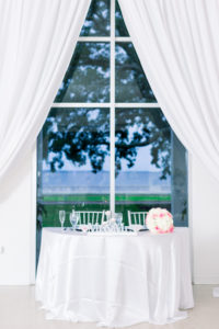 Garden-Glam Wedding Reception Decor, Waterfront View Sweetheart Table with White Linen, Pink and White Roses Floral Bouquet, White Draping | Wedding Venue Tampa Garden Club | Wedding Photographer Shauna and Jordon Photography