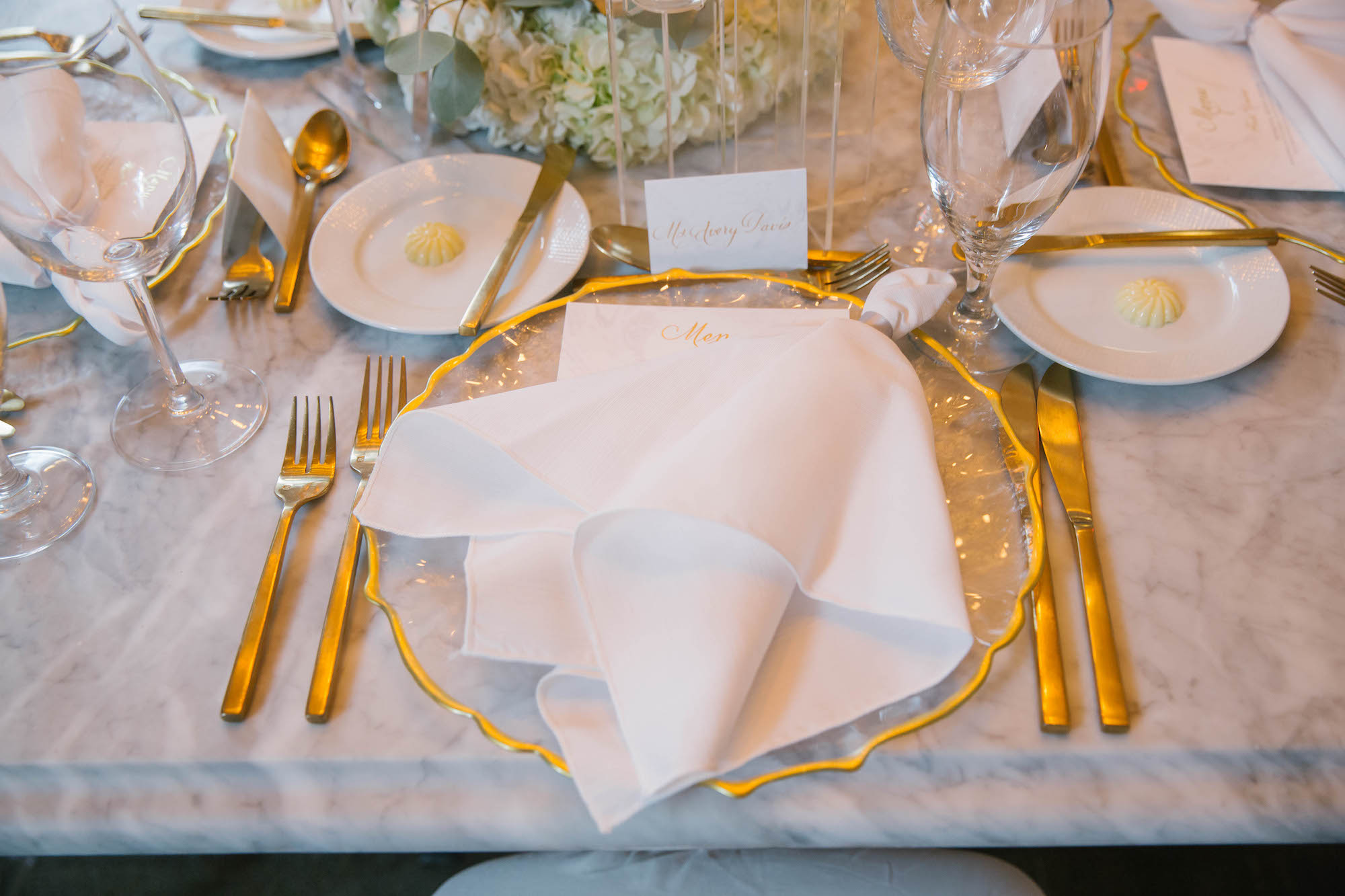 Elegant Wedding Reception Decor, Gold Rimmed Chargers with Gold Flatware and White Linen on Marble Table | Tampa Bay Wedding Planner Parties A'la Carte