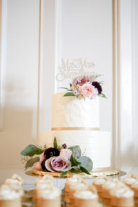 Elegant Spring Time Inspired Wedding Cake, Classic White Two Tier Buttercream Cake with Textured Frosting, Purple, Pink and Mauve Rose Floral Accents with Custom Cake Topper and Dessert Table | Tampa Bay Wedding Cake and Dessert Bakery The Artistic Whisk | Florida Wedding Photographer Lifelong Photography Studio | St. Pete Wedding Planner Blue Skies Weddings and Events