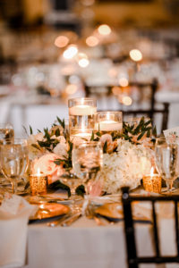 Tampa Wedding Venue Avila Golf & Country Club | Indoor Ballroom Reception with Chiavari Chairs and Chandeliers | White and Blush Dusty Rose | Low Floating Candle Centerpiece with Hydrangea Roses and Greenery