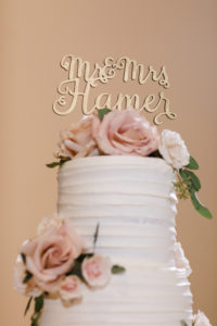Ribbed Textured Buttercream Wedding Cake with Fresh Flowers Rusty Rose and Calligraphy Gold Cake Topper