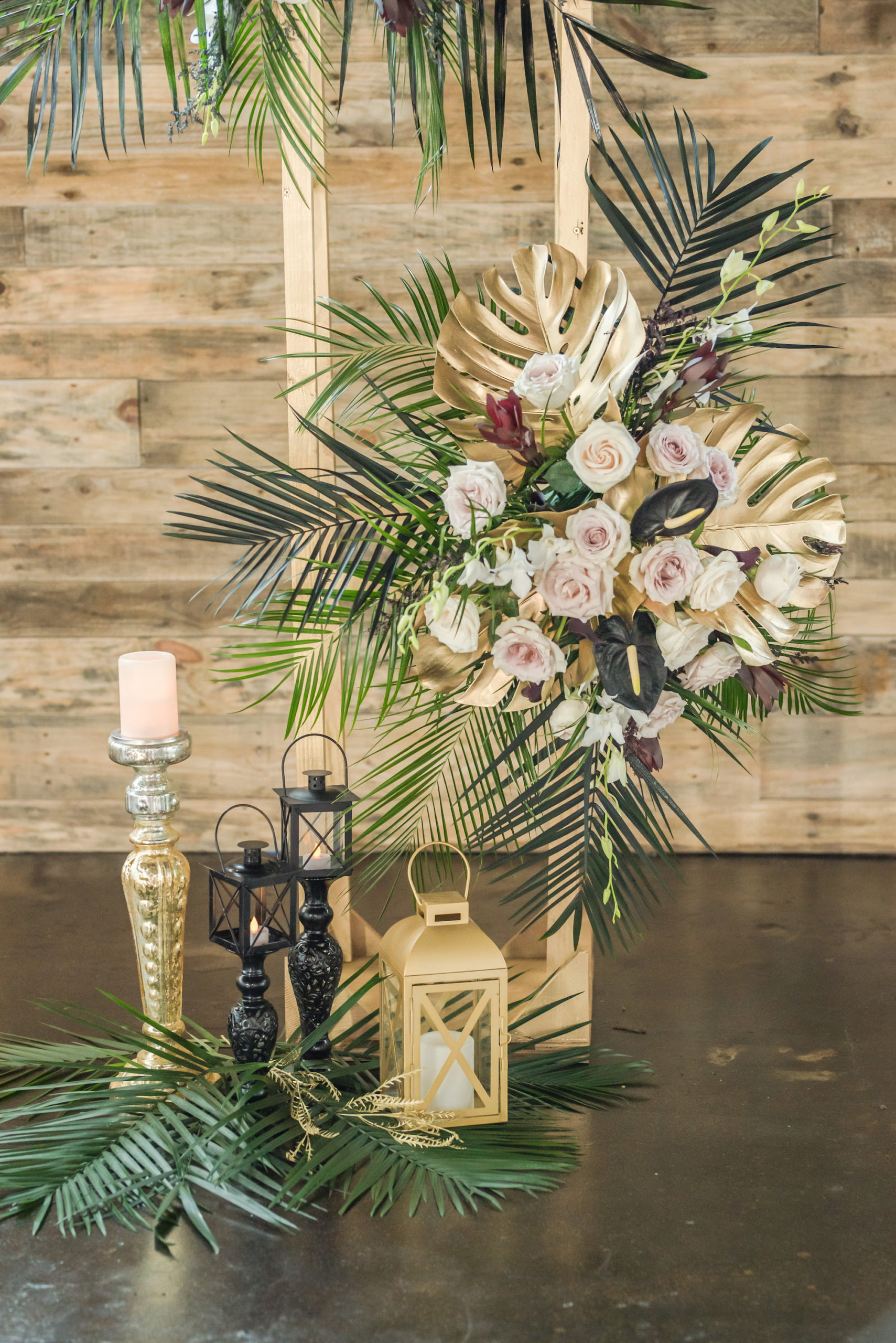 Dark Luxe, Romantic Wedding Styled Shoot, Tall Gold Geometric Stand with White and Blush Pink Roses, Palm Fronds and Gold Monstera Leaves, Gold Lantern, Black Candles | Tampa Bay Wedding Planner Elegant Affairs by Design | Madeira Beach Wedding Venue The West Events Sapce