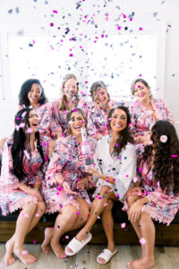 Fun Pink and Gray Confetti Portrait with Bride and Bridesmaids in Matching Pink Floral Robes and Champagne | Tampa Bay Wedding Photographer Shauna and Jordon Photography