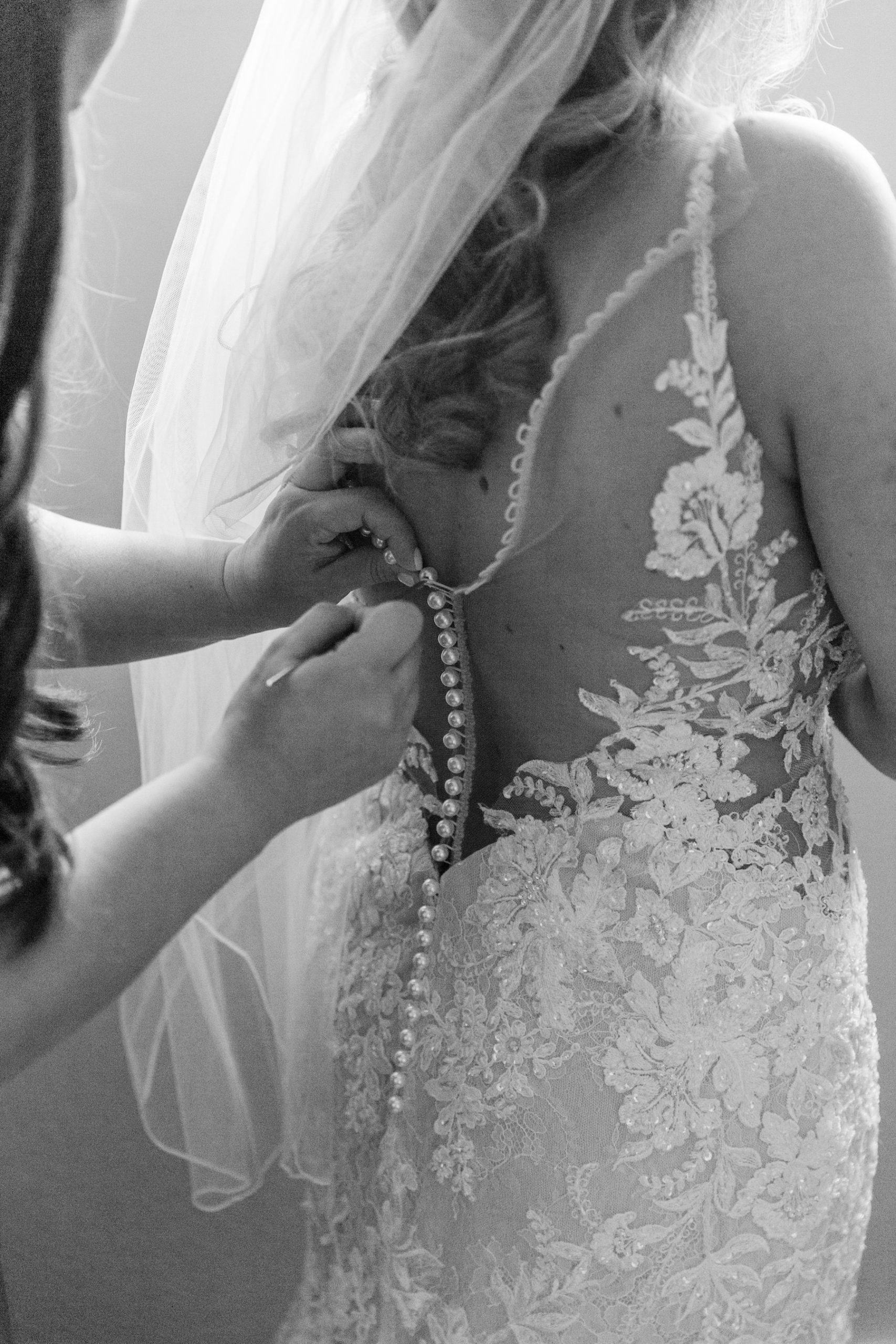 Ivory and Champagne Illusion Lace Sheath Wedding Gown by Martina Liana | Mom Helping Bride Get Dressed and Ready