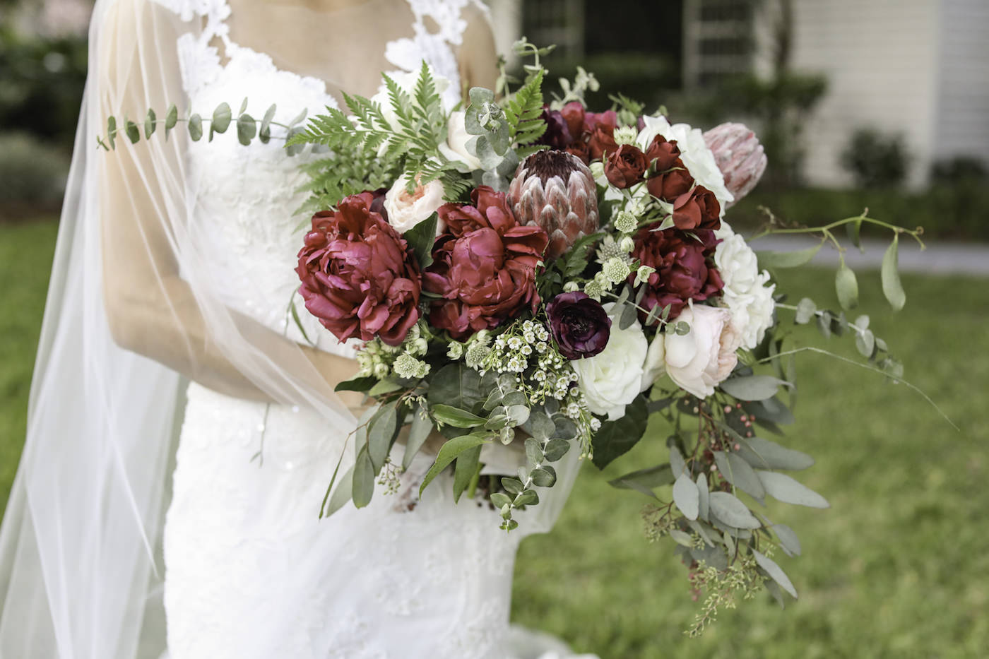 Bride Holding Bright Colorful, Red, Blush Pink and Ivory Roses with Greenery Floral Bouquet | Wedding Photographer Lifelong Photography Studio | Tampa Wedding Planner Blue Skies Weddings and Events
