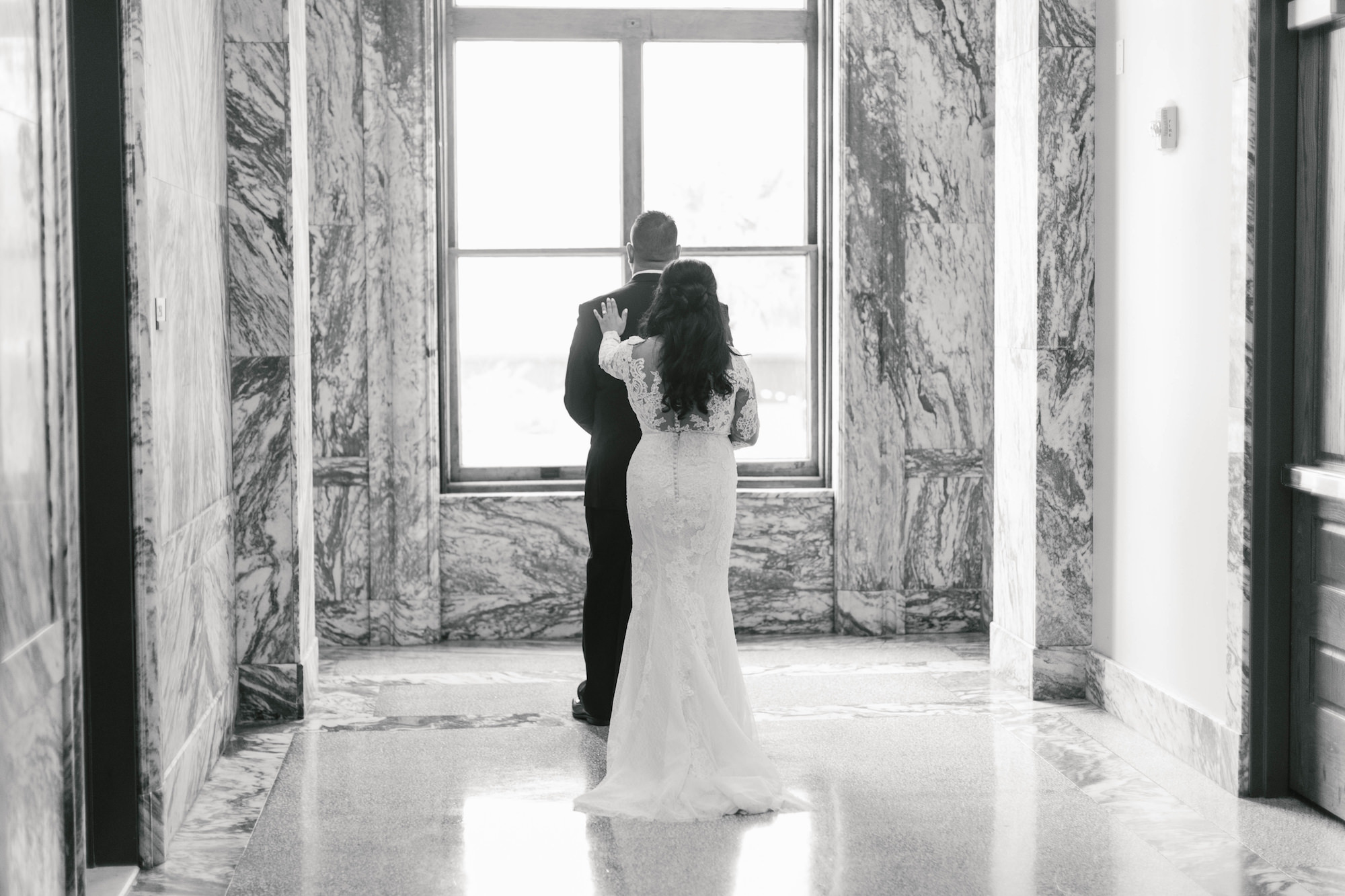 Romantic Bride Jessica from Parties A'la Carte and Groom Black and White First Look Wedding Portrait at Historic Courthouse Tampa Wedding Venue Le Meridien