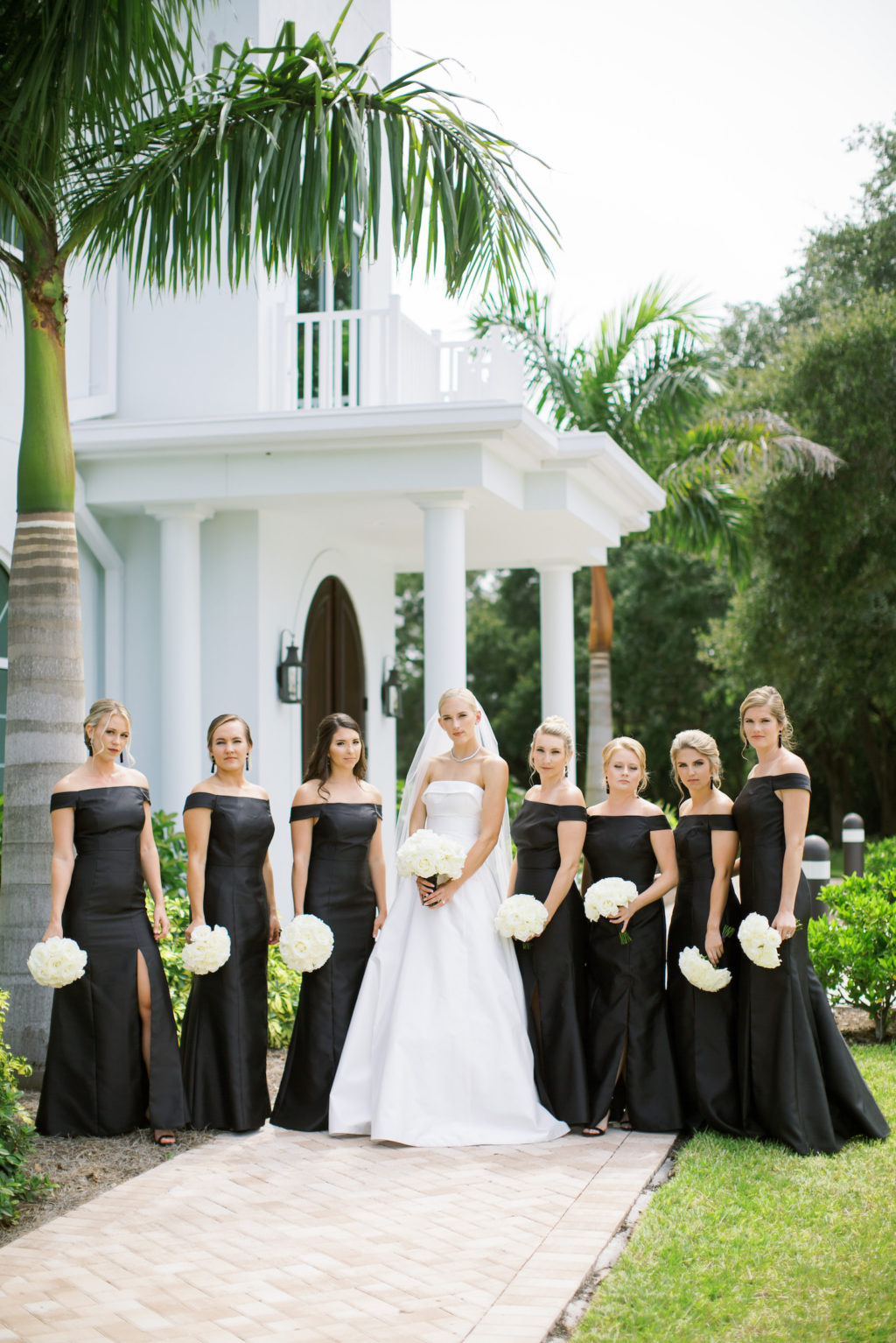 Classic Tampa Bride with Bridesmaids in Matching Off the Shoulder Dresses Holding White Floral Bouquets | Safety Harbor Traditional Church Wedding Venue Harborside Chapel