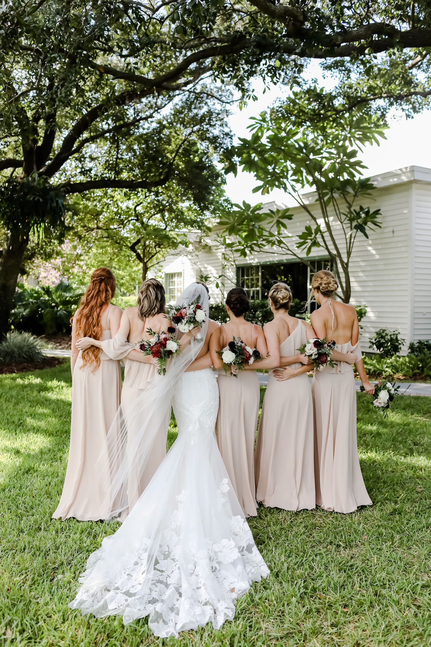 Bride in Lace Wedding Dress with Bridesmaids in Neutral Nude Dresses | Tampa Wedding Planner Blue Skies Weddings and Events | Wedding Photographer Lifelong Photography Studio | Bridesmaids Dress Shop Bella Bridesmaids