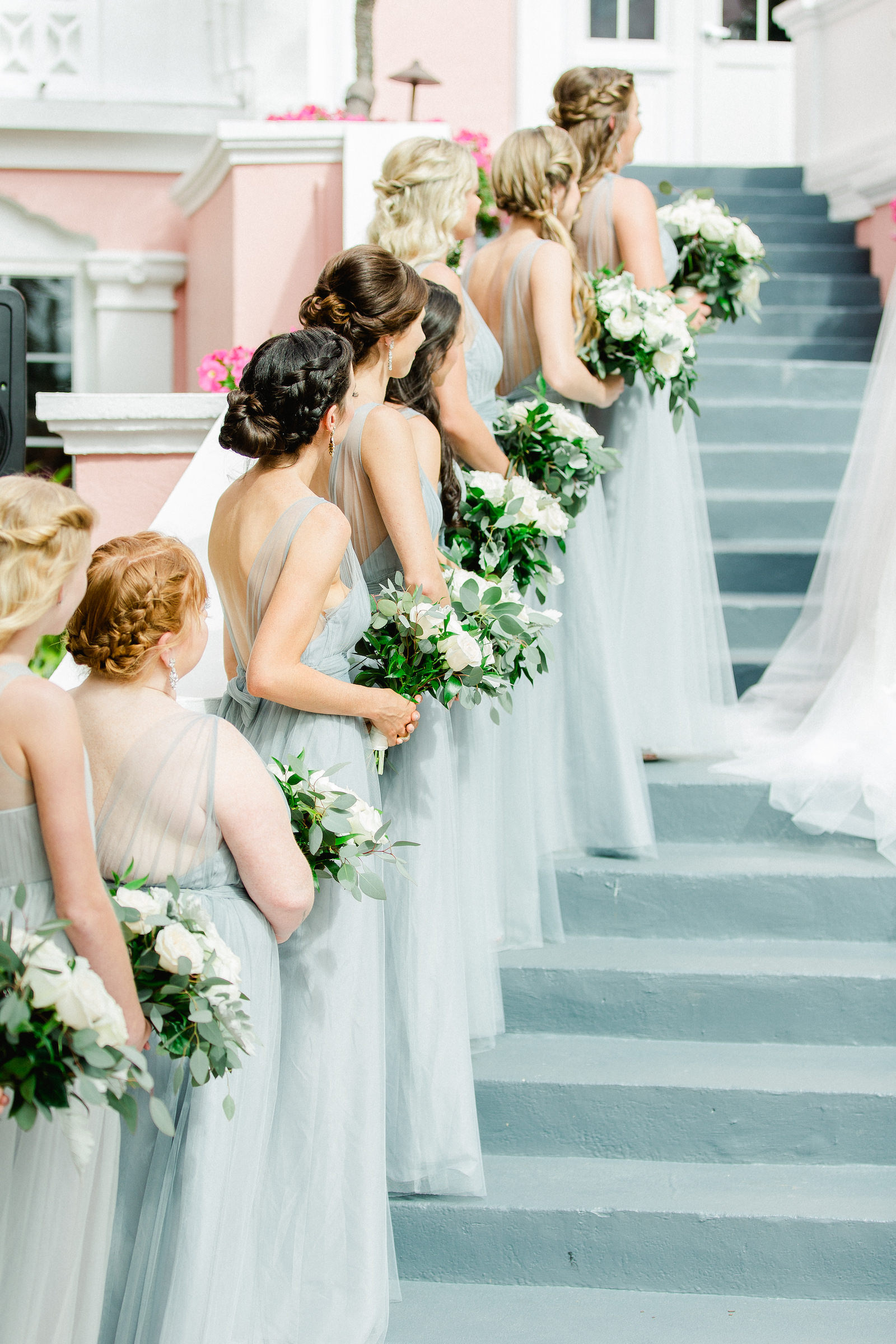 Staircase Wedding Ceremony | Dusty Blue Grey Tulle Bridesmaid Dresses | St Pete Beach Wedding Venue The Don Cesar | Classic Greenery White Flowers Bouquets | Isabel O'Neil Bridal Collection | Bella Bridesmaids
