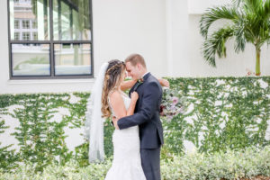 Downtown St. Pete Bride and Groom First Look Portrait, Bride Holding Mauve and Purple Floral Bouquet with Greenery | Florida Wedding Wedding Photographer Lifelong Photography Studio | Tampa Bay Wedding Venue The Birchwood