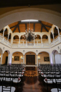 Indoor Ballroom Wedding Ceremony with Black Chiavari Chairs and Chandelier | Elegant Tampa Bay Wedding Venue Avila Golf & Country Club