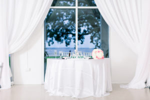 Garden-Glam Wedding Reception Decor, Waterfront View Sweetheart Table with White Linen, Pink and White Roses Floral Bouquet, White Draping | Wedding Venue Tampa Garden Club | Wedding Photographer Shauna and Jordon Photography