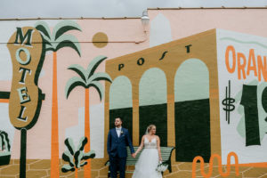 Florida Bride and Groom Wedding Portrait in Front of J&S Signs Wall Mural | Tampa Bay Wedding Photographer Bonnie Newman Creative