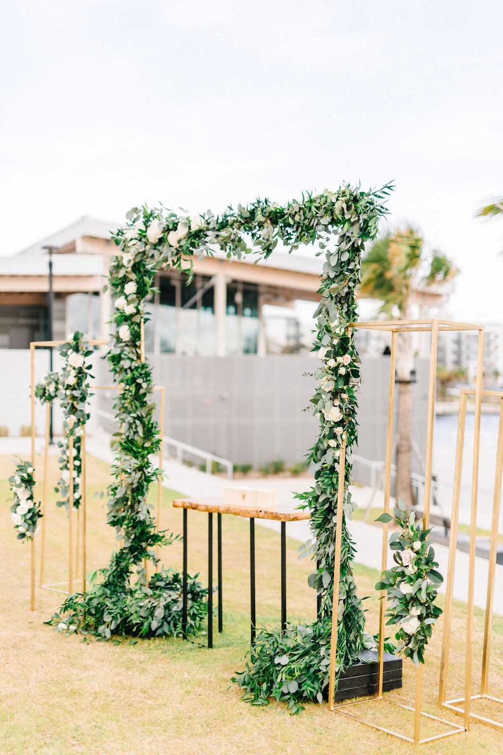Elegant Tampa Bay Waterfront Wedding Ceremony and Decor, Timeless Garden Inspired Decorations with Greenery Garland Arch, Gold Modern Accents, White, Ivory and Blush Pink Florals, Outdoor on Hillsborough River with Downtown's Skyline in Backdrop, Tampa River Center | Florida Wedding Planner UNIQUE Weddings and Events