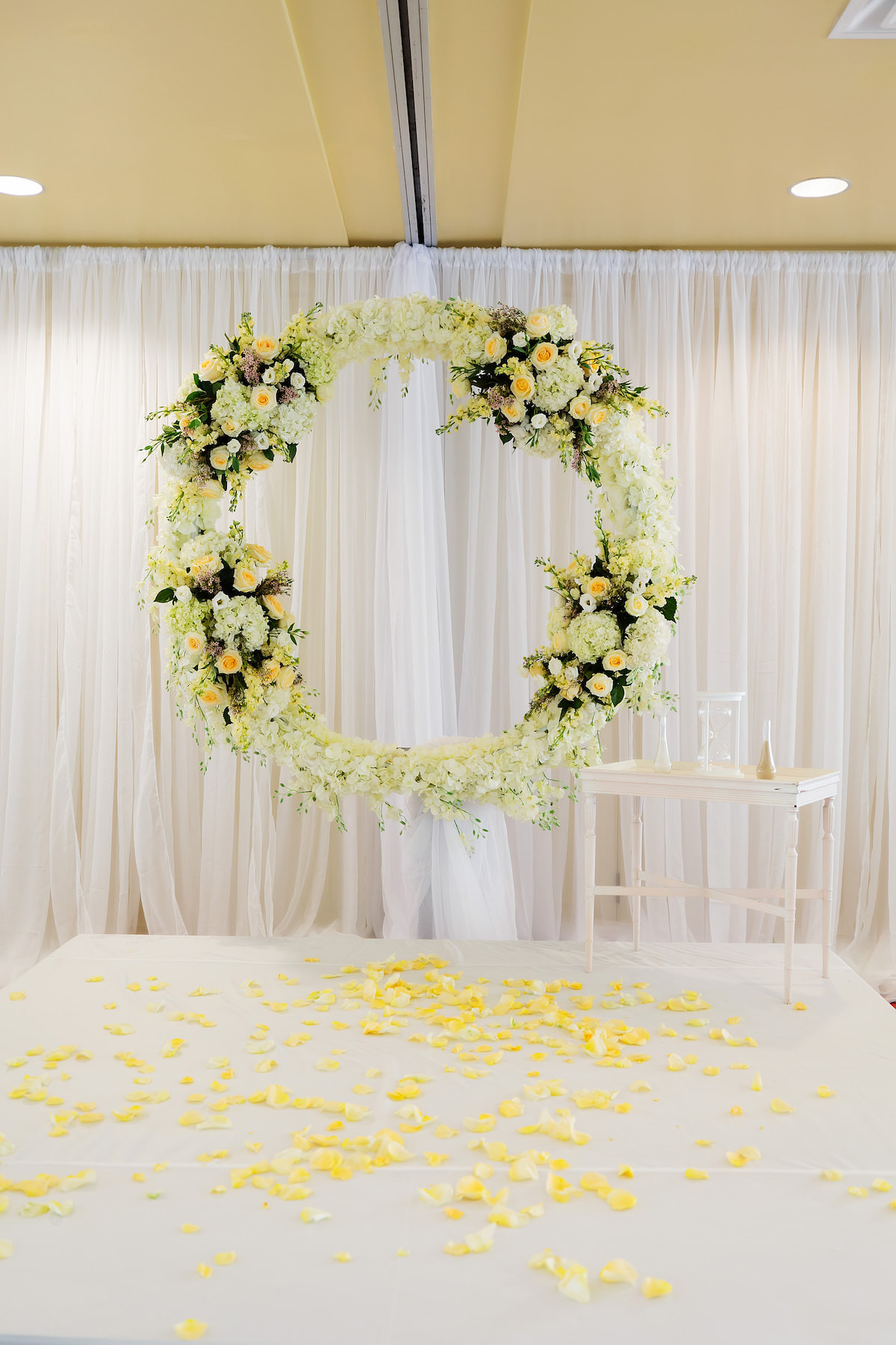 Romantic Classic White Hydrangeas, Rose Petals, Roses, Yellow Florals in Circular Wreath | Tampa Bay Wedding Planner Special Moments Event Planning