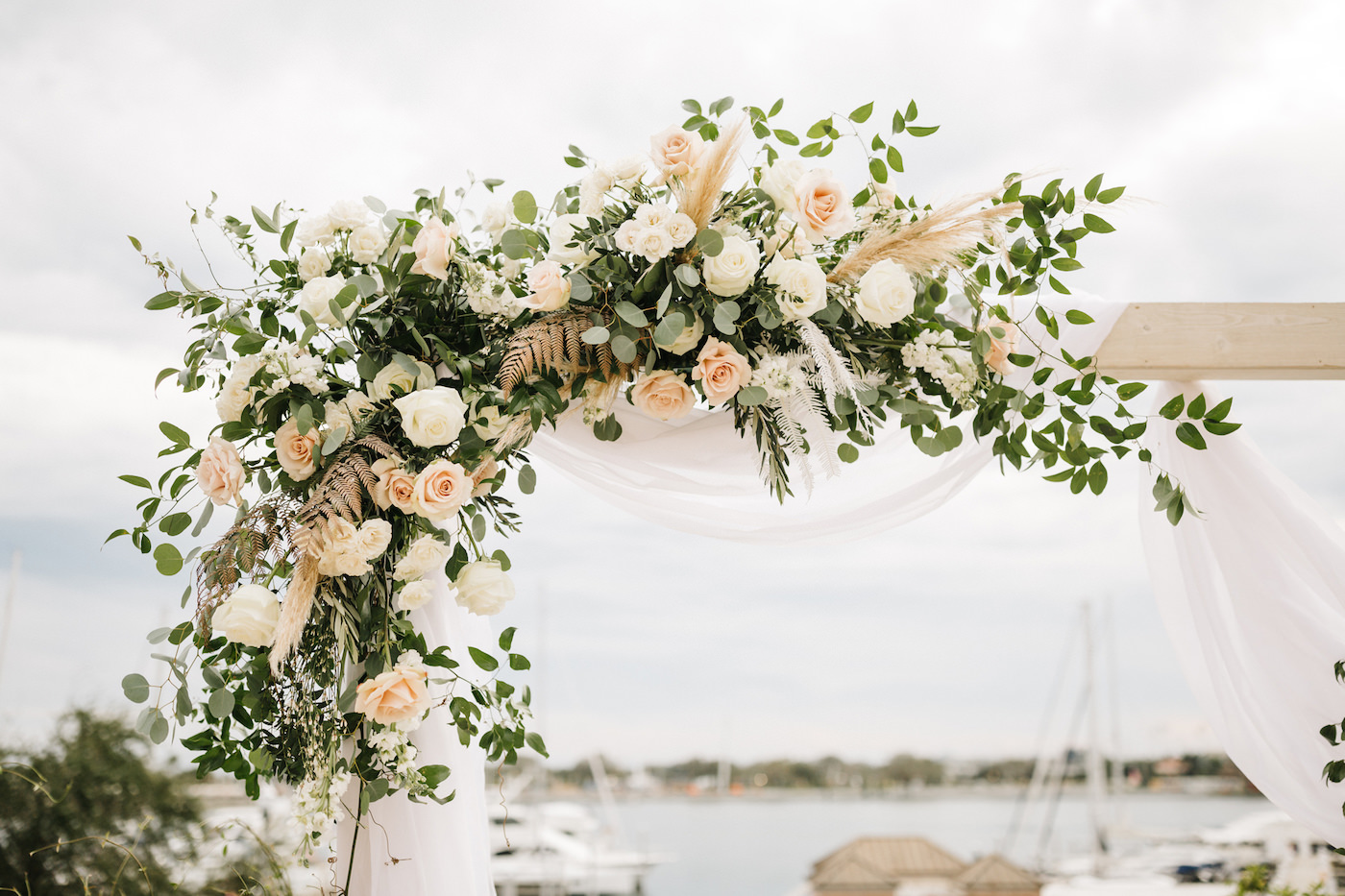Boho Chic Outdoor Waterfront Ceremony, White Wooden Arch with White Linen Draping, Decorated with Lush Ivory Flowers and Blush Pink Roses, Pampas Grass Bouquets with Greenery | Wedding Venue The Esplanade Location of the Vinoy Renaissance Resort in Downtown St. Petersburg | Tampa Bay Luxury Wedding Planner Parties A’ La Carte