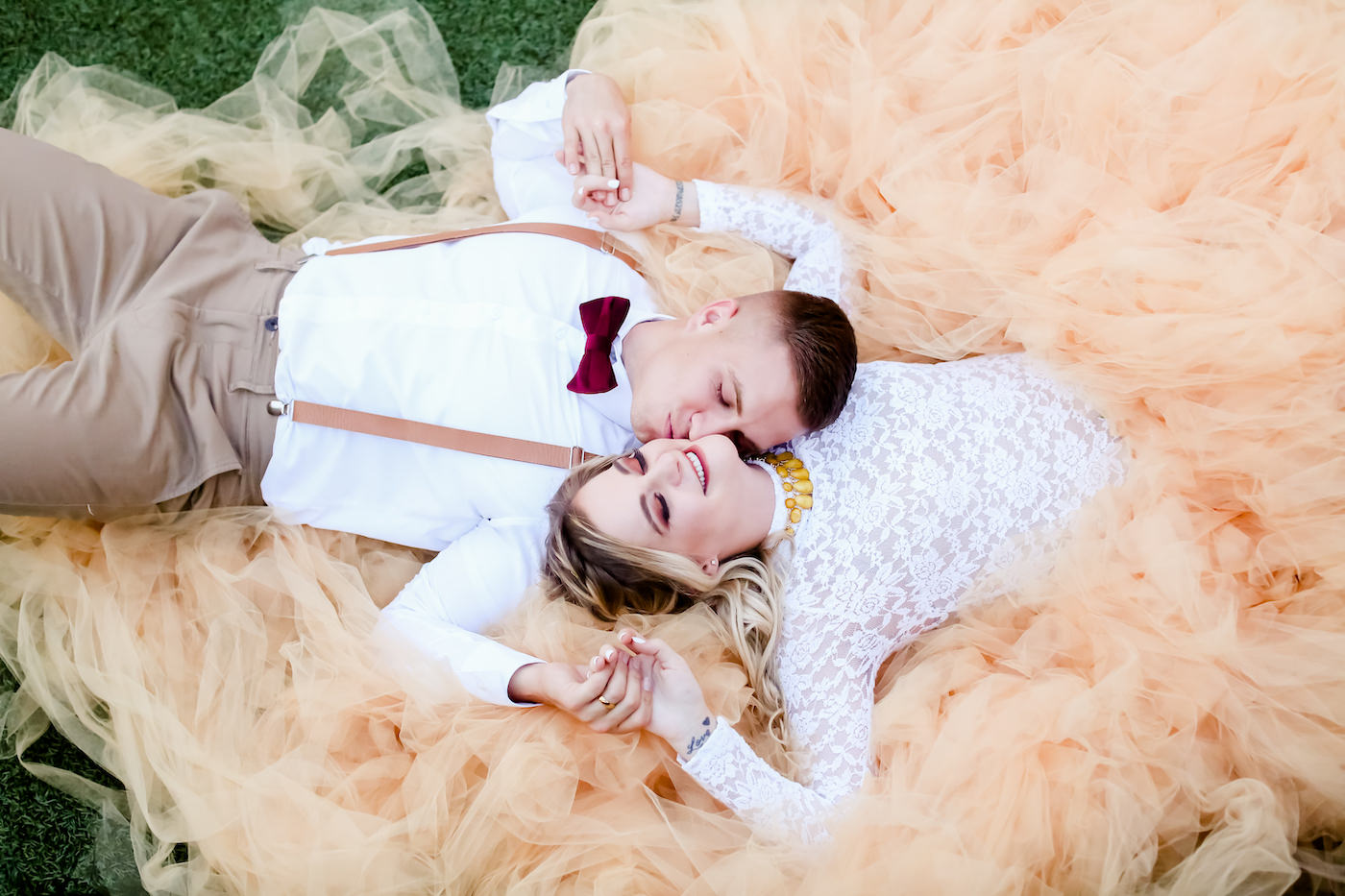 Bohemian Inspired Tampa Bay Bride and Groom Creative Wedding Portrait, Boho Bride Wearing Oversized Blush Orange Long Tulle Skirt, White Lace and Illusion Long Sleeve Top, Yellow Necklace, Groom in Brown Suit with Suspenders and Velvet Bowtie | Downtown St. Petersburg Wedding Planner Blue Skies Weddings and Events | Florida Wedding Photographer Lifelong Photography Studio
