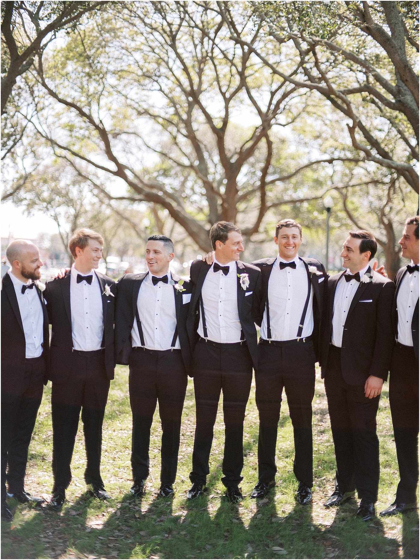 Groom and Groomsmen Portraits wearing Classic Black Suit Tuxedo and Bow Ties with Suspenders