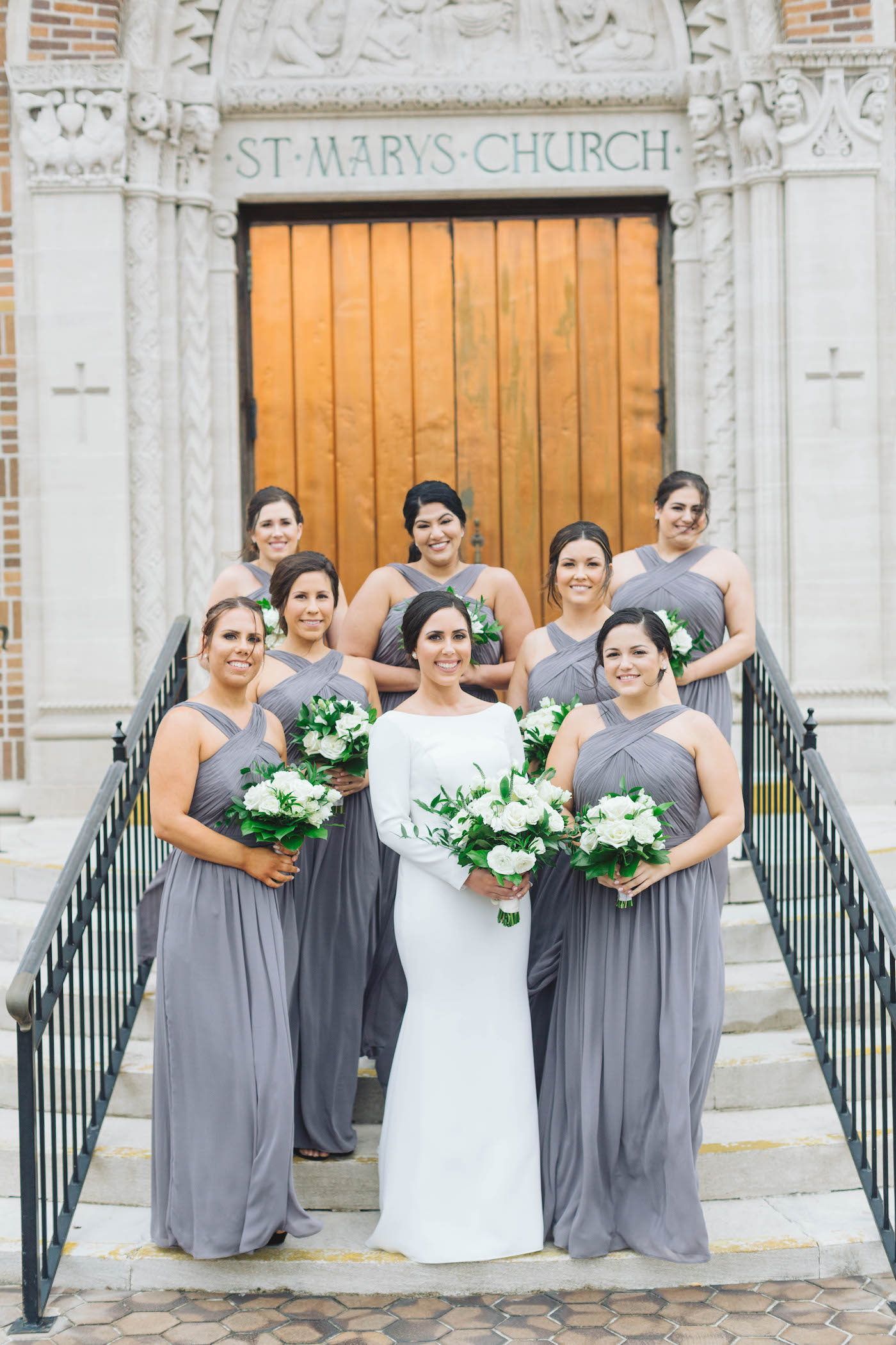 Florida Wedding Bridal Party Portrait, Bridesmaids Wearing Matching Long Dark Slate Gray Watters Dresses, Bride Wearing Timeless White Mikaella Bridal Wedding Dress, Holding Ivory and White Floral Bouquet | St. Petersburg Wedding Venue St. Mary Our Lady of Grace Catholic Church | Tampa Bay Wedding Planner Parties A'La Carte | Downtown St. Pete Wedding Florist Bruce Wayne Florals | South Tampa Bridesmaids Dress Shop Bella Bridesmaids