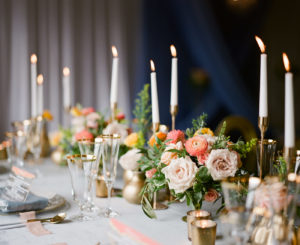 Romantic Wedding Decor at Reception, Low Floral Centerpieces with Peach, Pink and Yellow Roses, Greenery, Tall Taper Candles with Gold Accents | Florida Wedding Planner Kelly Kennedy Weddings and Events | Kate Ryan Event Rentals