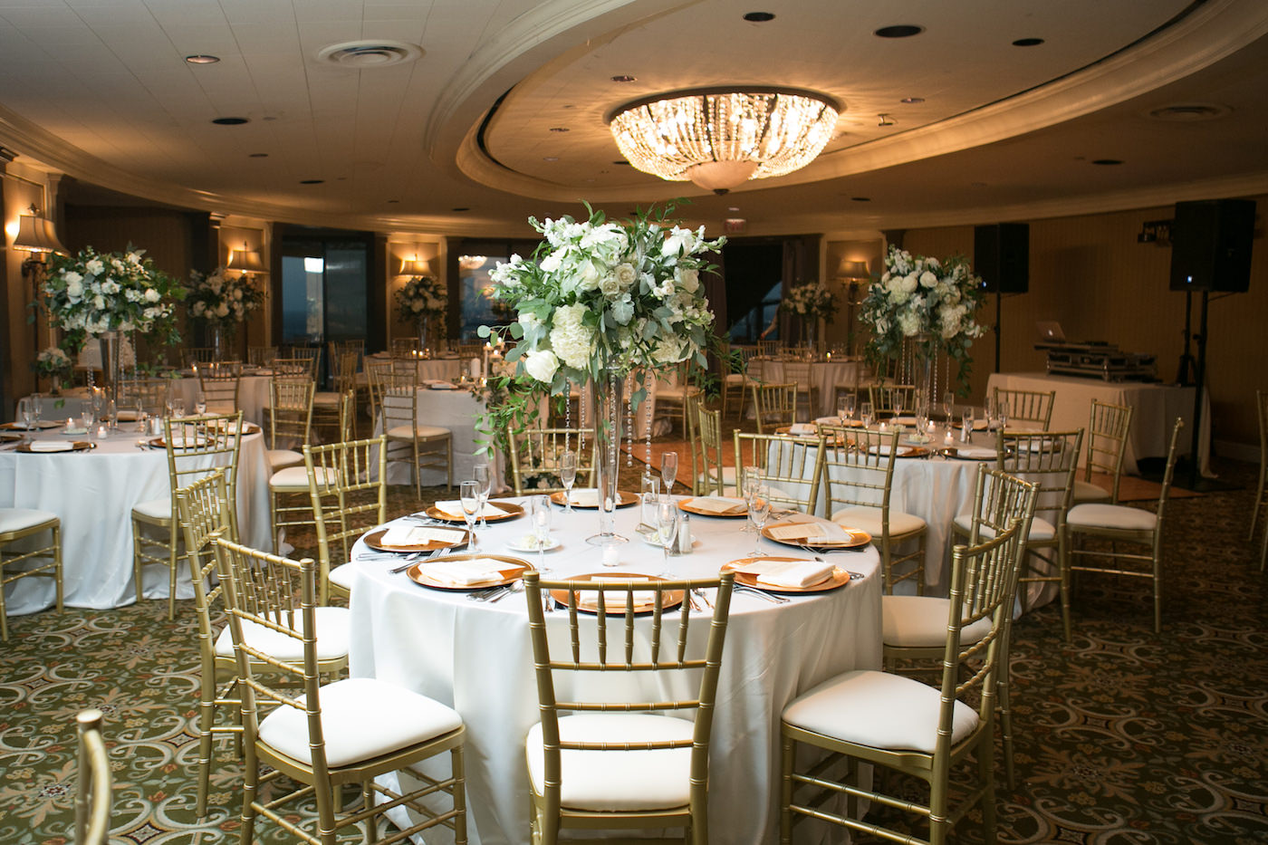 Romantic Classic Wedding Reception Decor, Round Tables with Gold Chiavari Chairs, Tall White Hydrangeas and Roses with Greenery and Hanging Crystals Floral Centerpieces, Gold Chargers | Wedding Photographer Carrie Wildes Photography | Ballroom Wedding Venue The Tampa Club