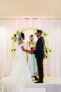 Classic Bride and Groom Exchanging Wedding Vows, Circular Wreath Ivory Floral Arch | Tampa Bay Wedding Planner Special Moments Events Planning