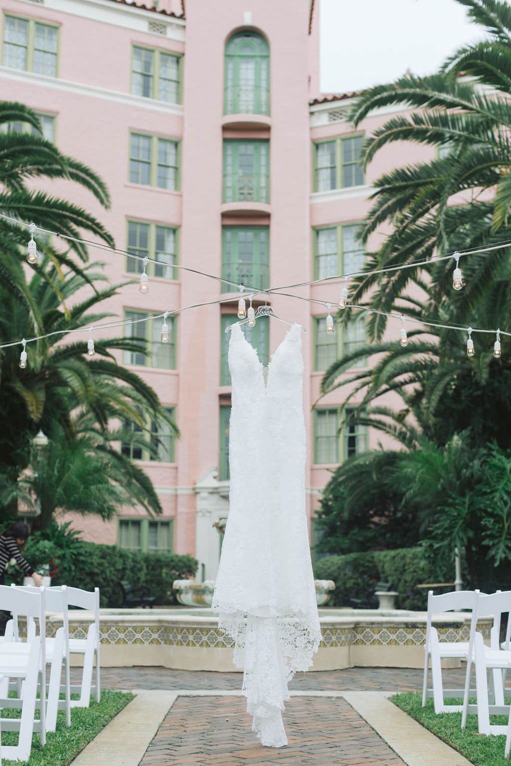Lace Deep Plunging V Neckline Wedding Dress Hanging Off String Lights | St. Petersburg Hotel Wedding Venue Vinoy Renaissance