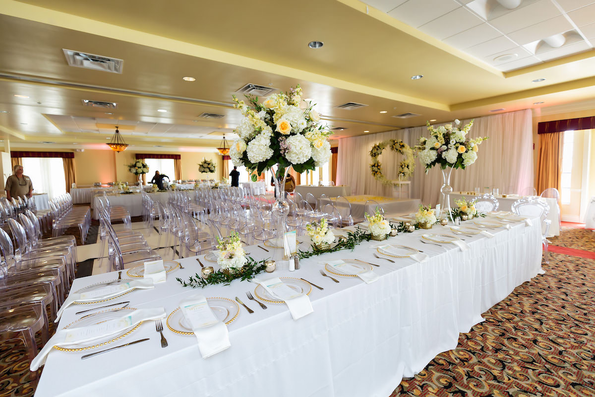 Classic Wedding Reception Decor, Long Feasting Table with White Linens, Tall White Hydrangeas, Yellow Roses Floral Centerpieces | Tampa Bay Wedding Planner Special Moments Event Planning | Clearwater Beach Wedding Venue Duvall Ballroom Center | Wedding Rentals Gabro Events Services